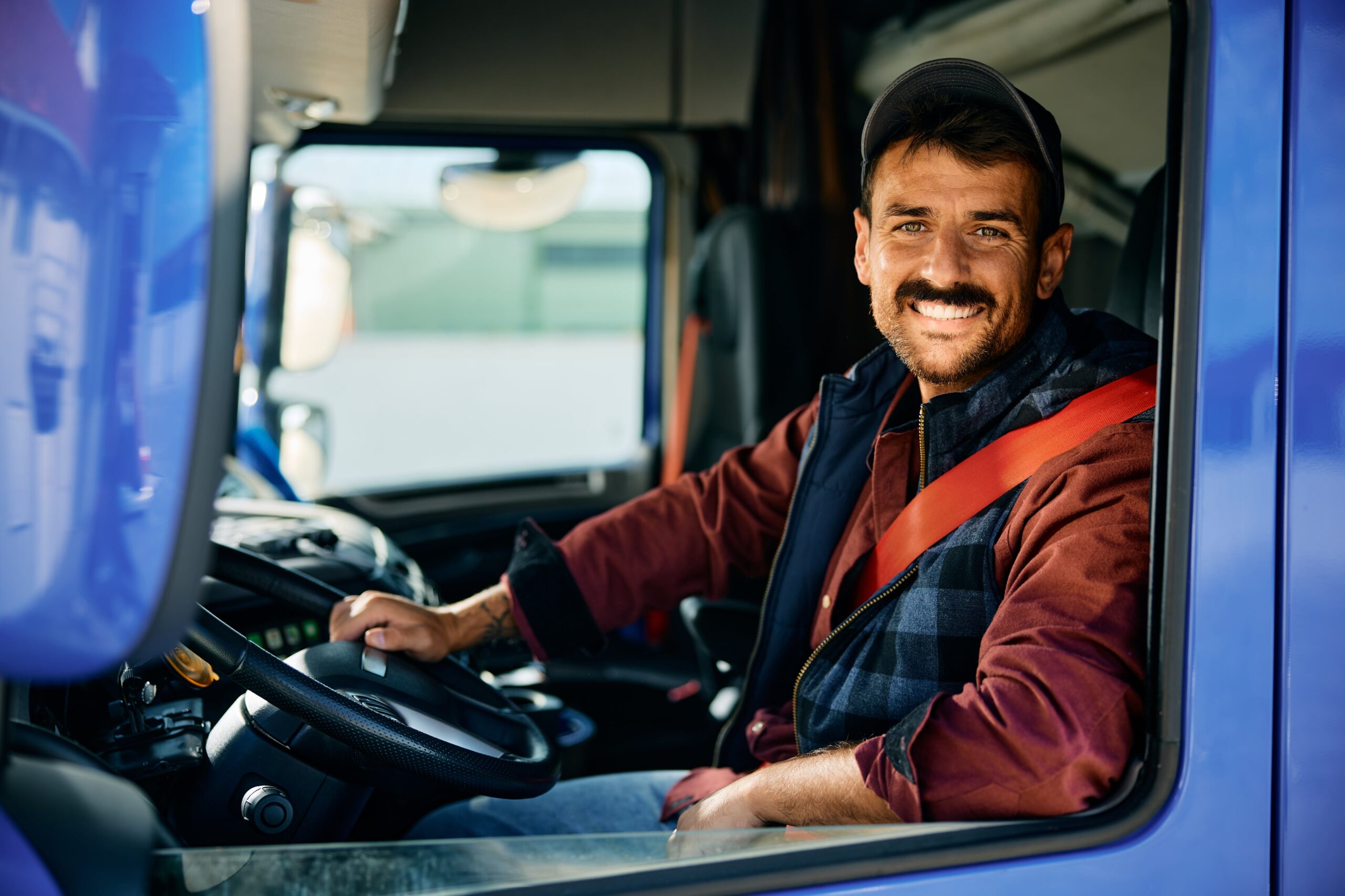 happy-professional-truck-driver-driving-his-truck-2024-01-05-20-32-05-utc-min
